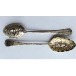 A heavy pair of embossed berry spoons, the bowls d