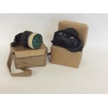 Two World War II gas masks. Est. £20 - £30.