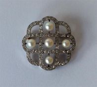 An Edwardian diamond and pearl brooch in white gol