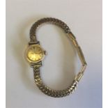 OMEGA: A lady's wristwatch with gilt dial. Est. £2