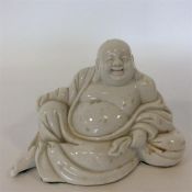 A Chinese figure of a seated Buddha. Est. £25 - £3