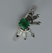 A stylish 18 carat emerald and diamond cluster rin