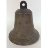 A heavy brass bell. Signed "NFS". Est. £30 - £40.