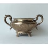 A helmet shaped sugar bowl, the feet decorated wit