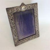 A large embossed picture frame heavily decorated w