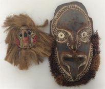 A tribal mask from Papua New Guinea together with