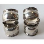 A heavy set of four napkin rings with beaded borde