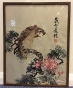 A framed and glazed Oriental silk tapestry of a bi