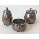 A stylish unusual Arts & Crafts three piece cruet.