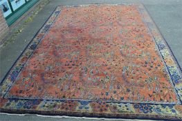 A large patterned carpet. Est. £80 - £100.