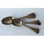 A group of four OE pattern dessert spoons together