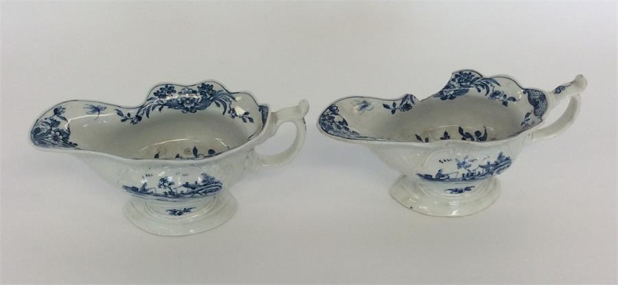 A pair of early English blue and white sauce boats