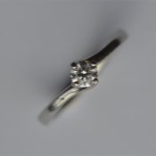 A small diamond single stone ring in claw mount. E