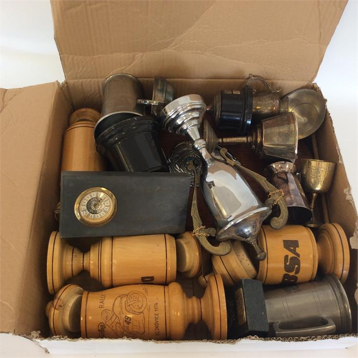 A quantity of old motor cycling trophies and cups.
