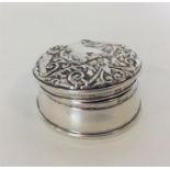 A large circular embossed top ring box with fitted