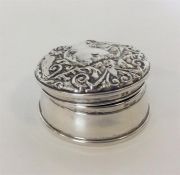A large circular embossed top ring box with fitted