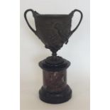 A 19th Century two handled bronze urn with brass c