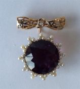 A large Antique amethyst and pearl brooch in gold