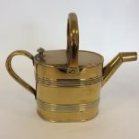 A small brass watering can. Est. £20 - £30.