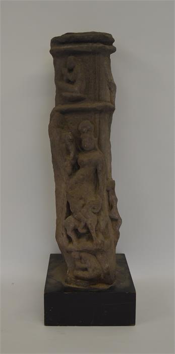 A tall carved stone column decorated with figures