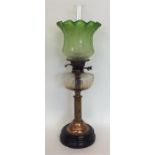 A large oil lamp with green glass shade. Est. £80