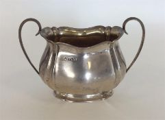 A two handled sugar bowl with gilt interior on spr