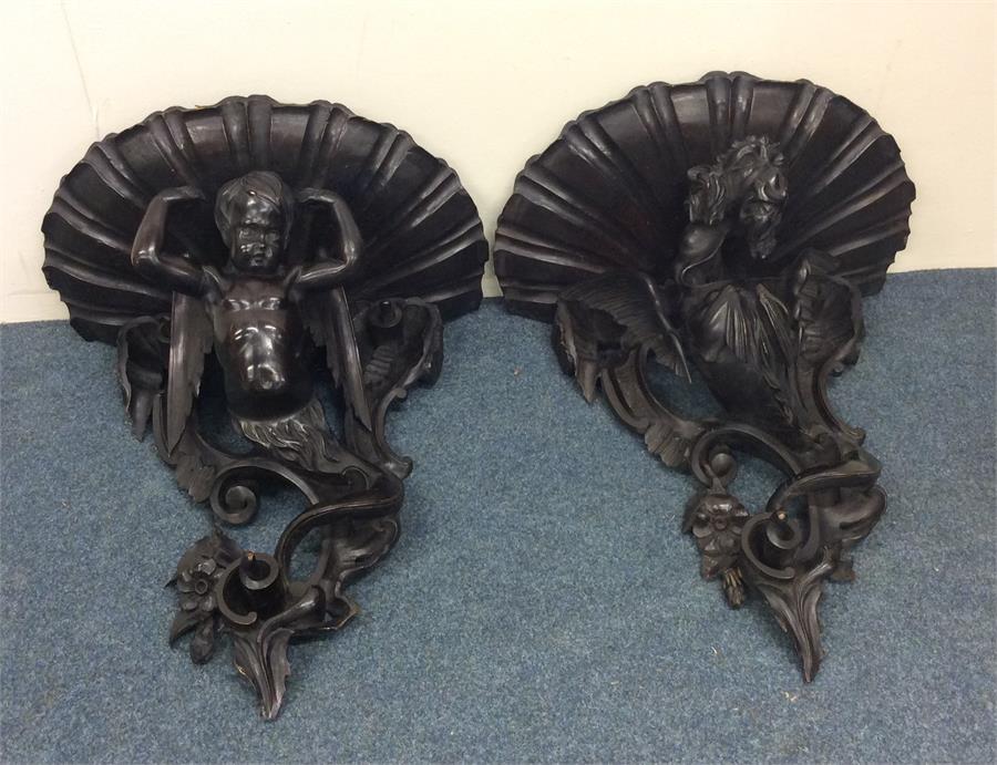 An impressive pair of large carved brackets mounte