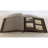 An Antique photograph album with numerous photogra