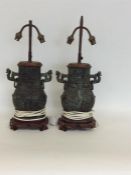 A large pair of brass and hardwood lamps of Easter