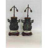 A large pair of brass and hardwood lamps of Easter