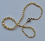 An Antique string of graduated pearls with a gold