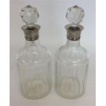 A tall pair of silver mounted decanters with glass