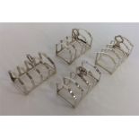 An unusual set of four toast racks on bracket feet