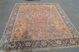 A large patterned carpet. Est. £80 - £100.