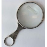 An unusual engine turned magnifying glass with rin