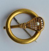 An 18 carat brooch in the form of a tennis racket