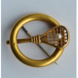 An 18 carat brooch in the form of a tennis racket