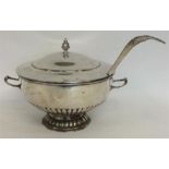 A massive punch bowl together with matching ladle