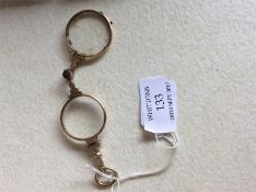 A pair of gilt engraved lorgnettes with spring mec