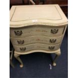 A painted serpentine front three drawer chest.