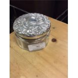 A silver topped dressing table jar.