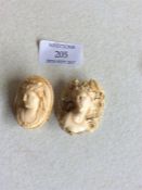 Two carved ivory cameos.
