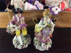 A pair of good decorative figures mounted with flo