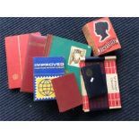 A collection of stamp albums, cigarette cards, and