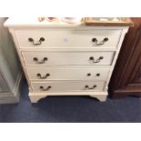 A painted chest of four drawers.