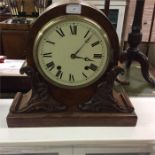 A mahogany mantle clock.