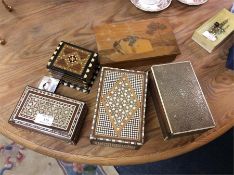 A shagreen box together with other inlaid boxes.