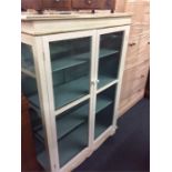 A white painted display cabinet.