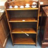 A small four tier oak bookcase.