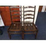 Ercol: A pair of rail back chairs.